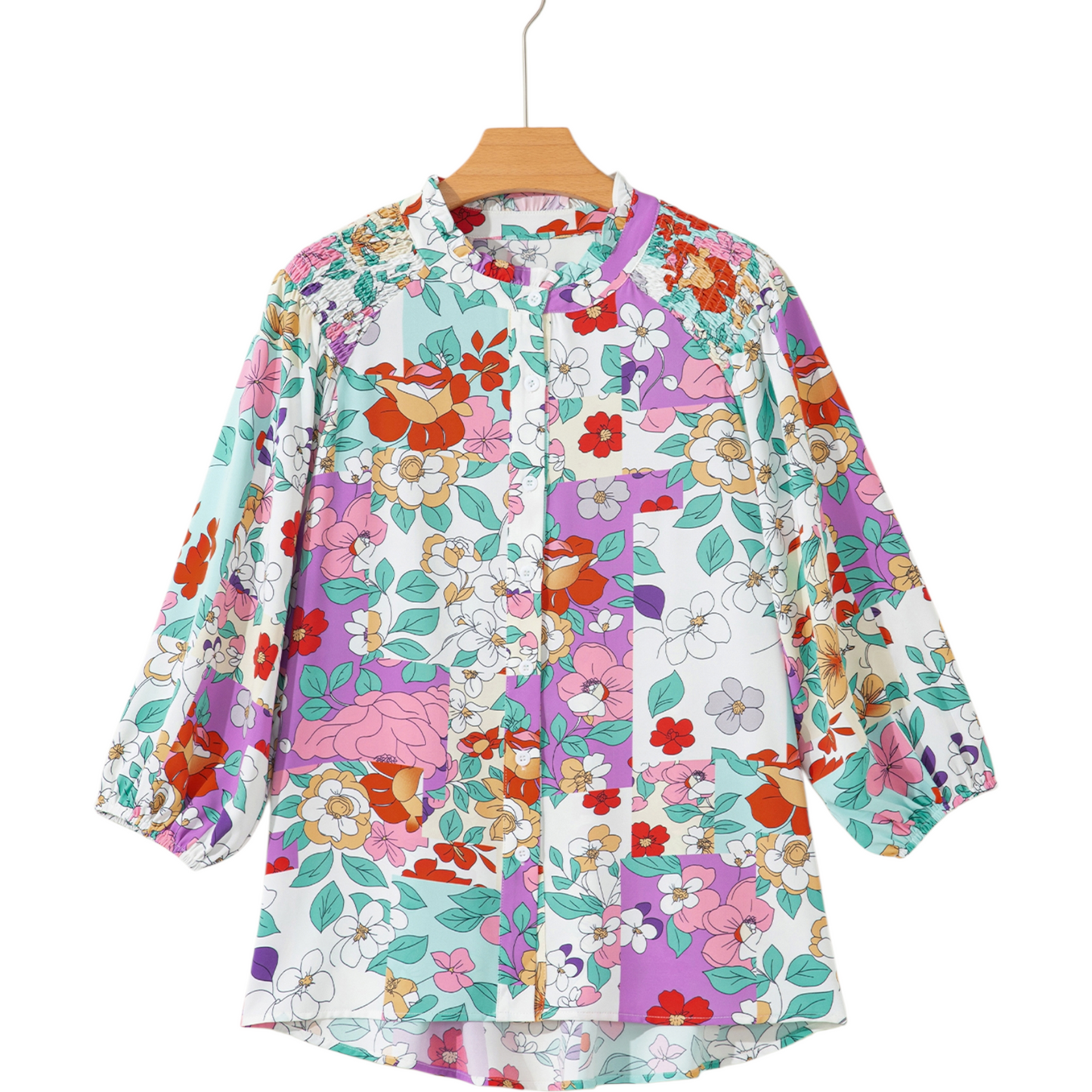 Floral patterned shirt on a hanger with a white background