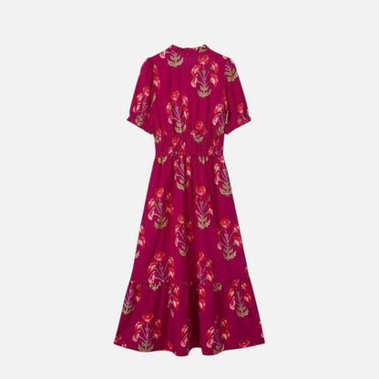 Back view flat lay of a fuchsia floral tiered maxi dress showcasing the cinched waist and flowing skirt.