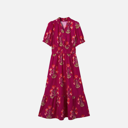 Front view flat lay of a fuchsia maxi dress with red and coral floral print, v-neckline, puff sleeves, and tiered skirt.