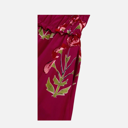 Close-up detail of the discreet side seam pocket on a fuchsia floral print tiered maxi dress.