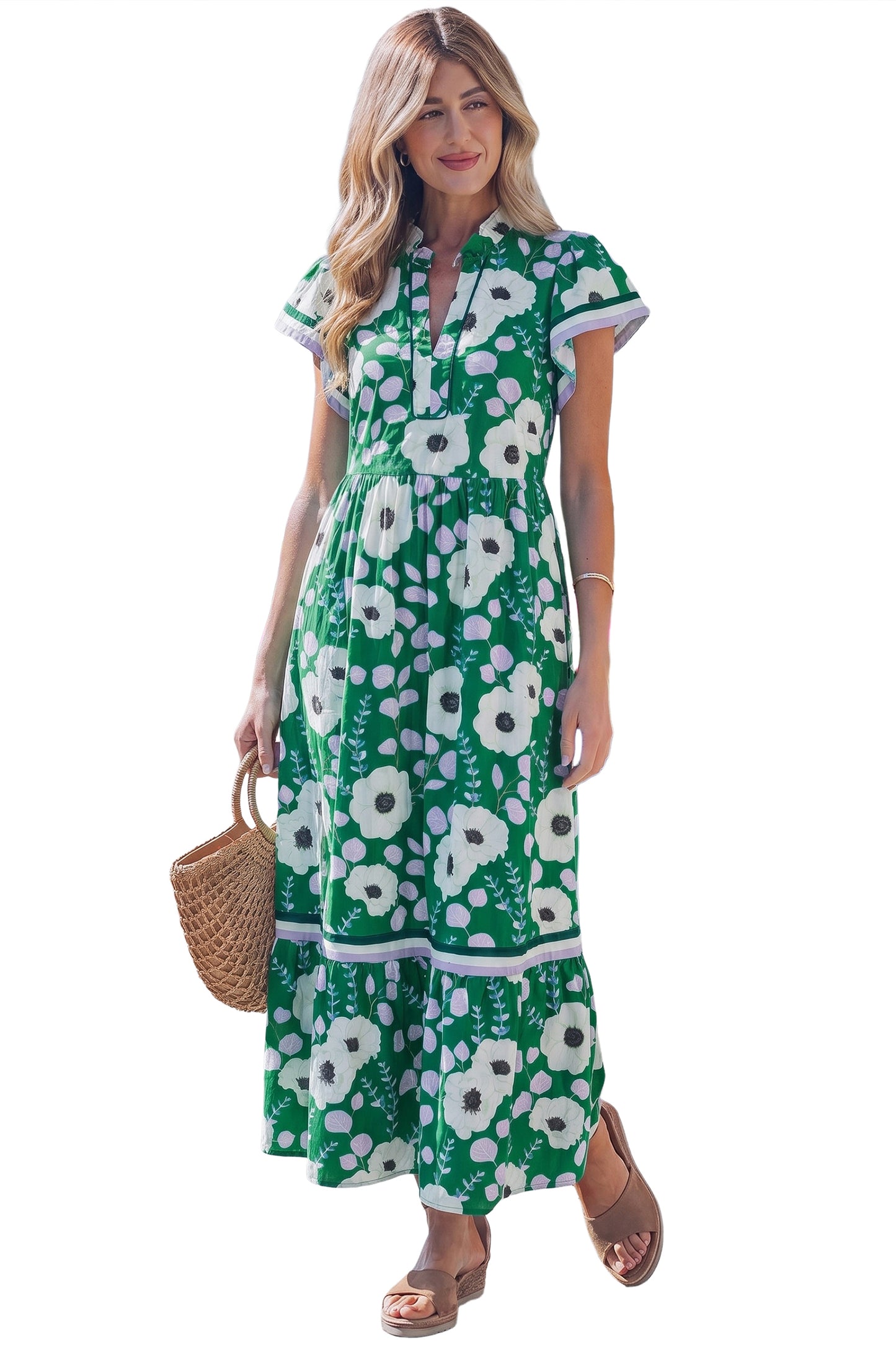 Woman wearing a green floral dress on a white background