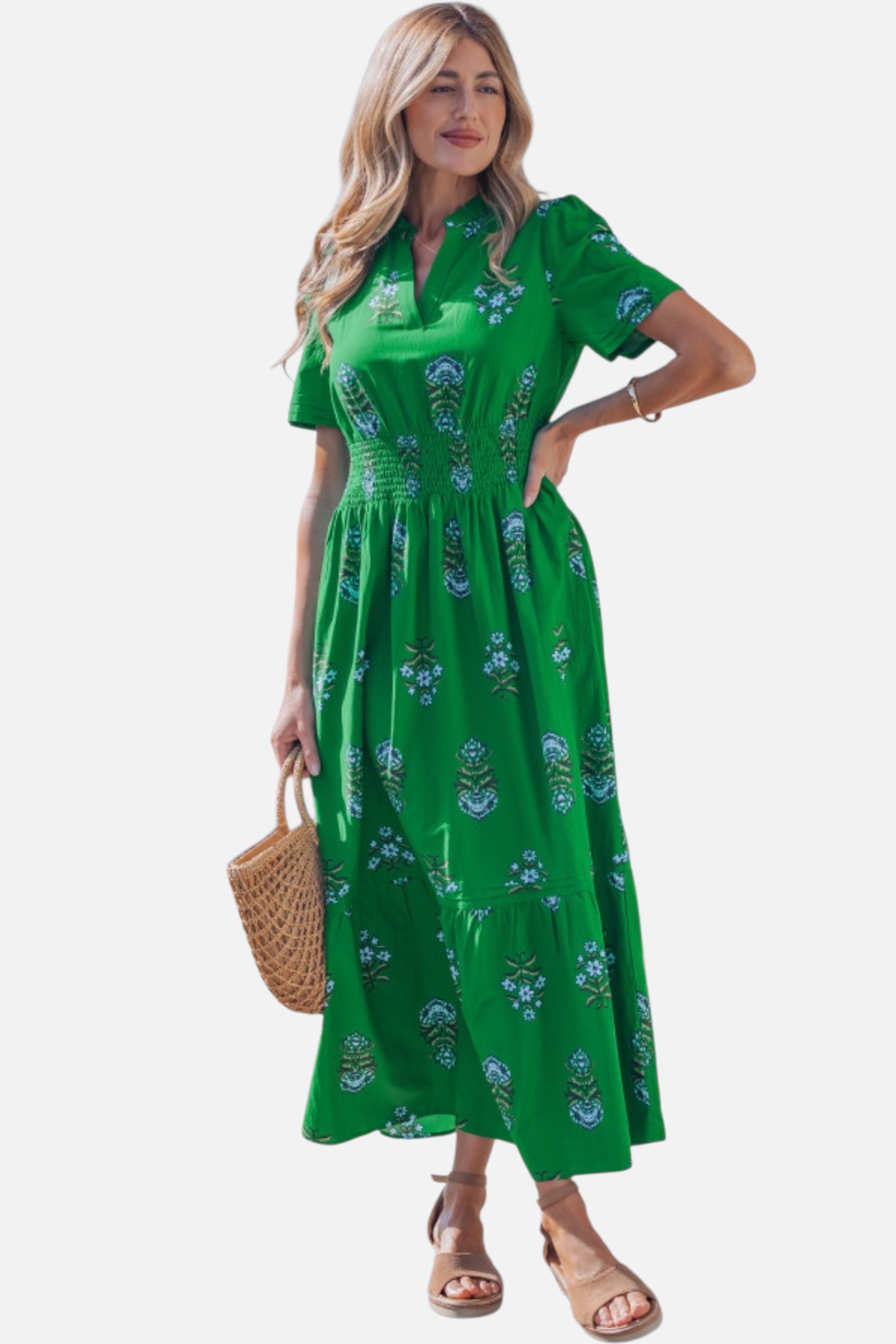Woman wearing a green floral dress on a white background