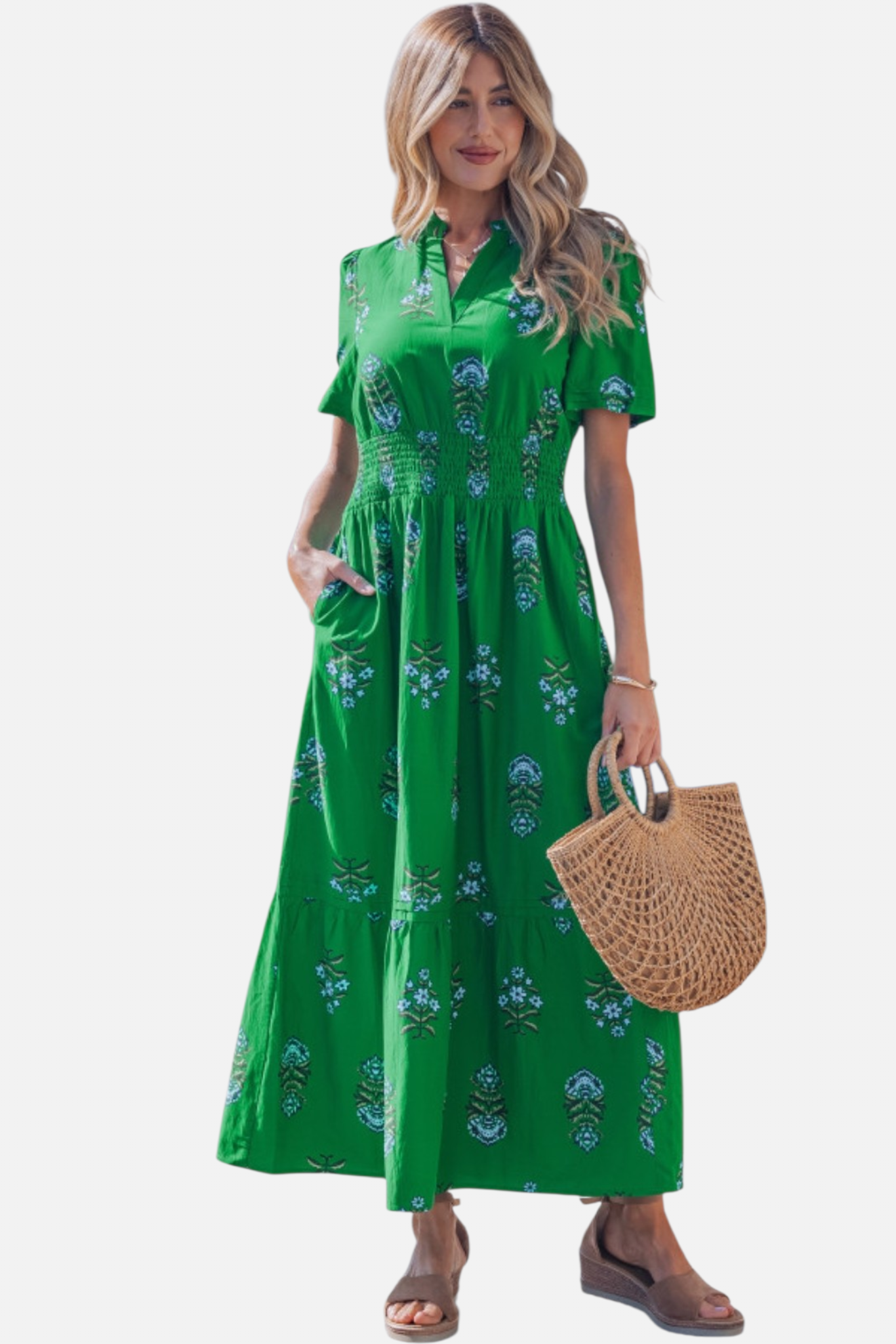 Full-length front view of the green shirred maxi dress, featuring a decorative floral pattern, short sleeves, and a flowing tiered skirt.