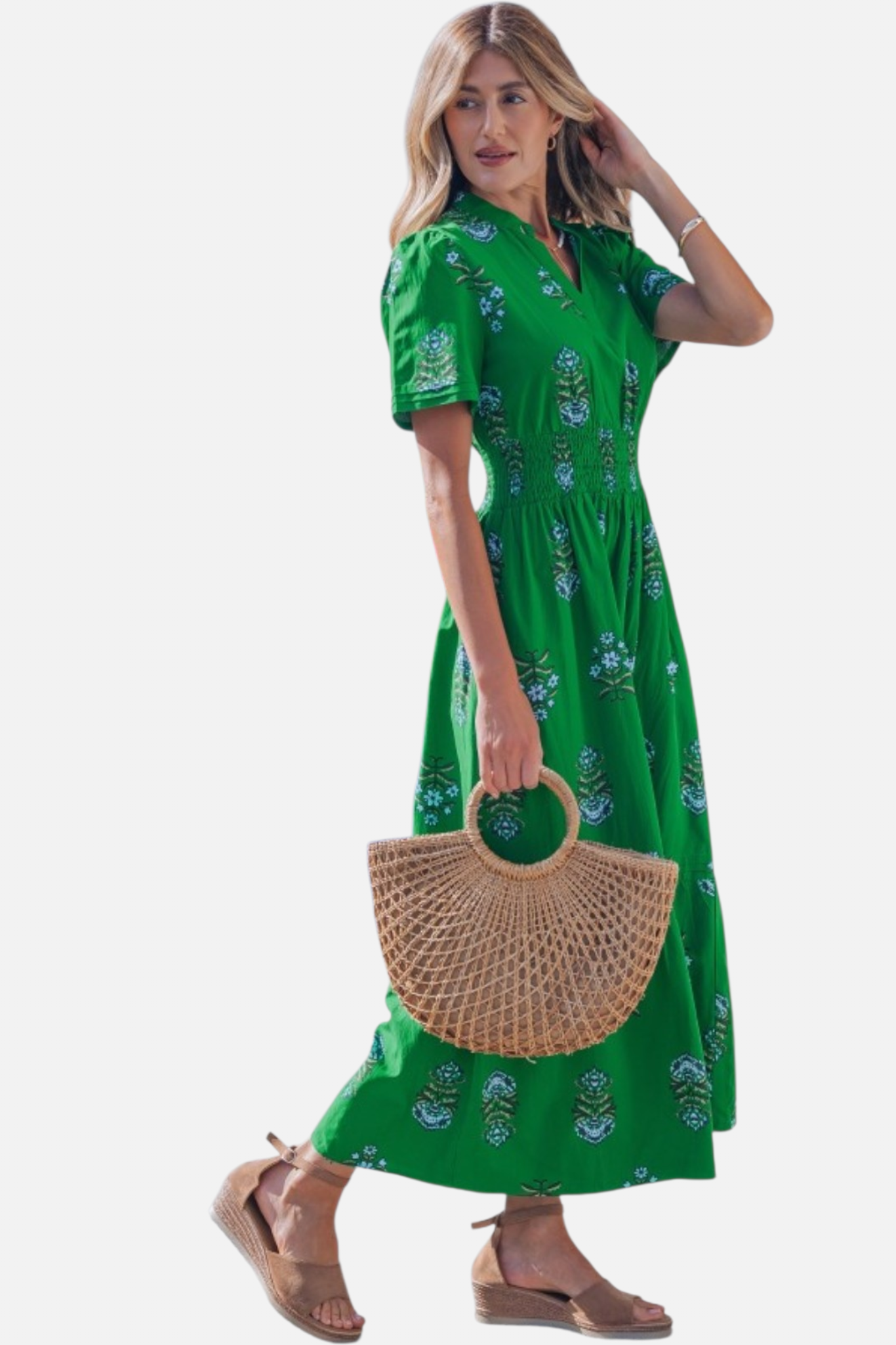 Side profile of the floral print maxi dress, illustrating the soft drape of the fabric and the elegant movement of the tiered skirt.