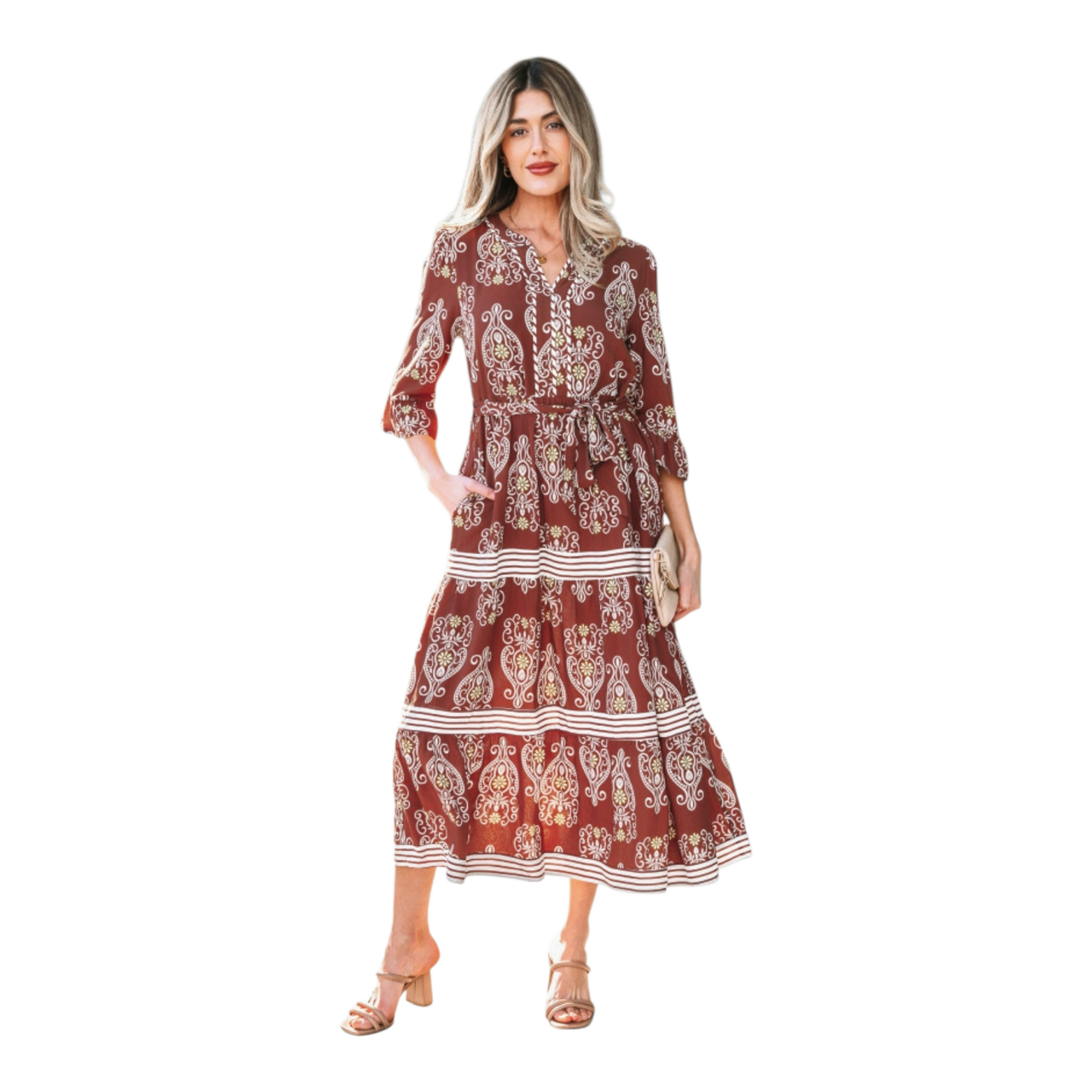 Woman wearing a rust-brown paisley floral maxi dress with a matching waist tie belt and flutter sleeves.