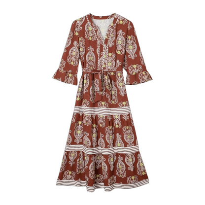 Front view of a tiered floral maxi dress in rust-brown, showing the mid-length sleeves and white horizontal border print.