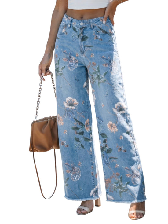 Floral-patterned jeans worn by a person on a white background styling with a brown leather bag.