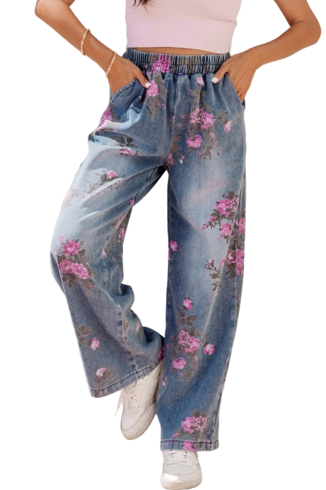 Person wearing floral denim pants with a plain background