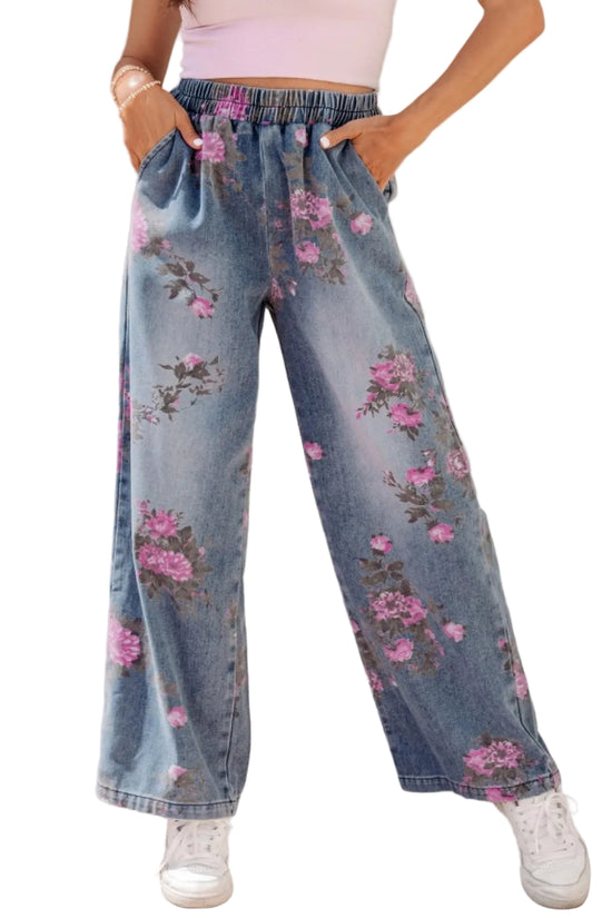 Person wearing floral denim pants with a plain background
