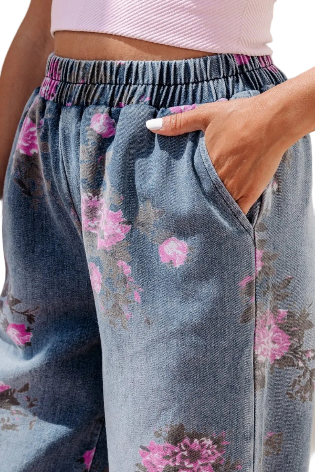 Floral-patterned jeans with a pink top worn by a person.