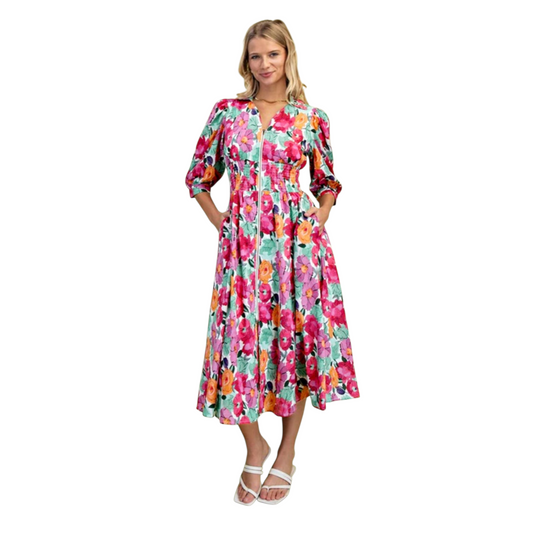 Floral print zip front shirred waist midi dress, front full length view on model with hands in pockets, styled with white strappy sandals