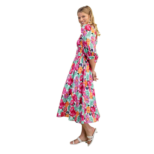 Floral print zip front shirred waist midi dress, side full length view showing flared midi skirt and puff sleeves, model smiling in white strappy sandals