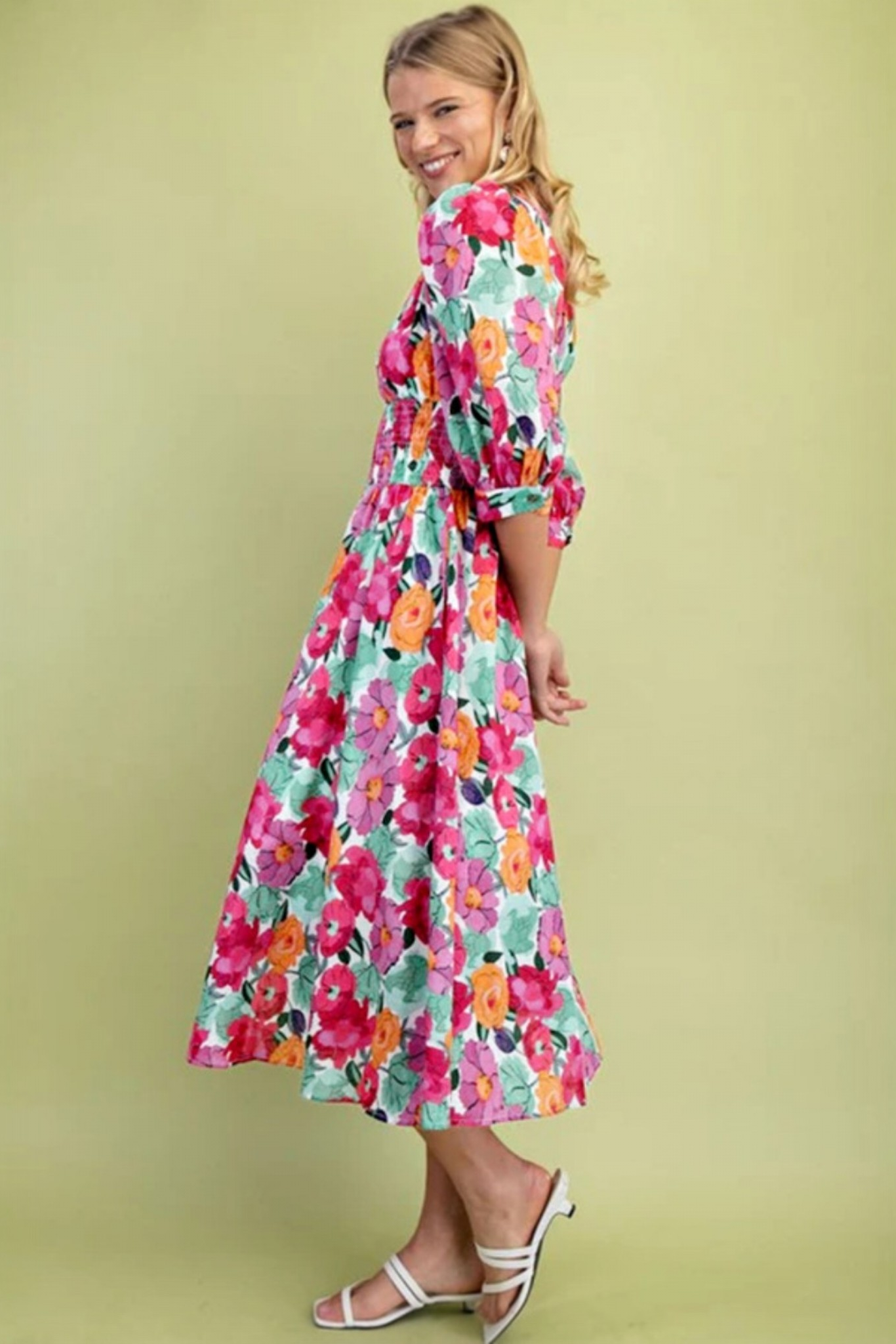 Floral print zip front shirred waist midi dress, side lifestyle view on smiling model, multicolour bold floral print with mint, pink, orange and purple blooms