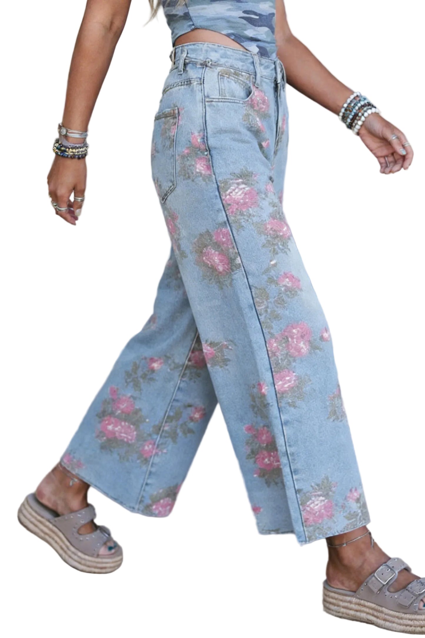 Person wearing floral jeans with a white background
