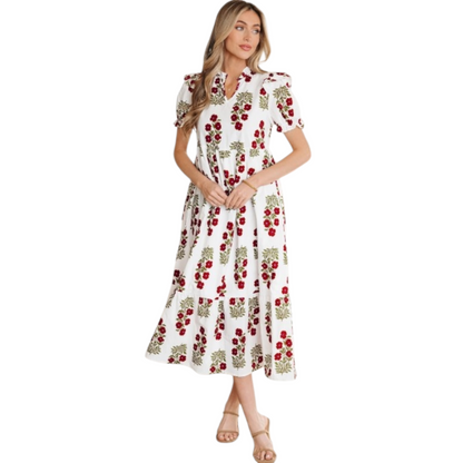 Woman wearing a white and red floral cotton midi dress with puff sleeves and a tiered ruffle hem.