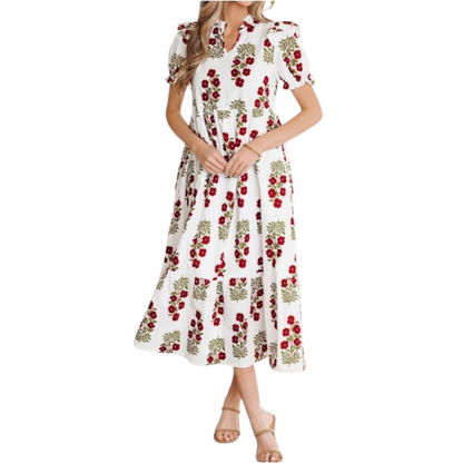 Woman wearing a white and red floral cotton midi dress with puff sleeves and a tiered ruffle hem.