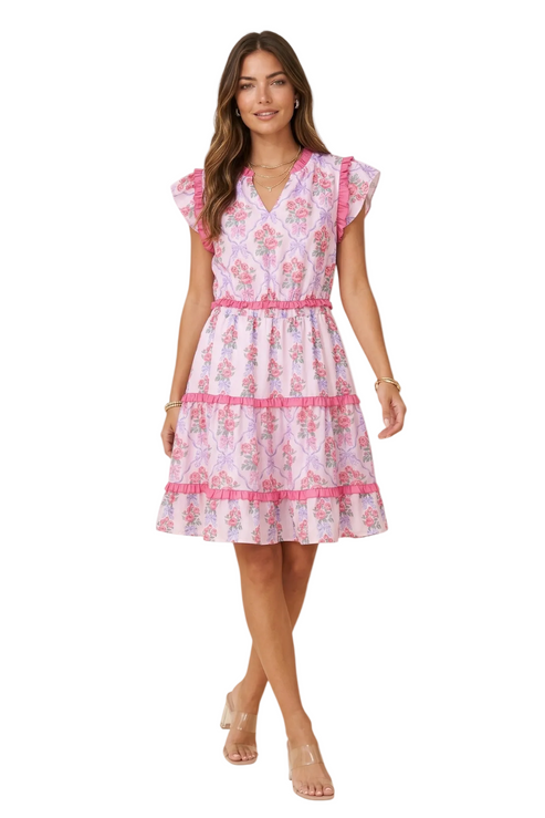 Full-length front view of a model wearing a V-neck floral mini dress with ruffled flutter sleeves against a white background.