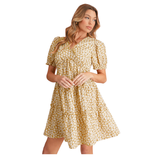 Yellow tiered midi dress with a smocked bodice, V-neckline, and feminine flutter sleeves.