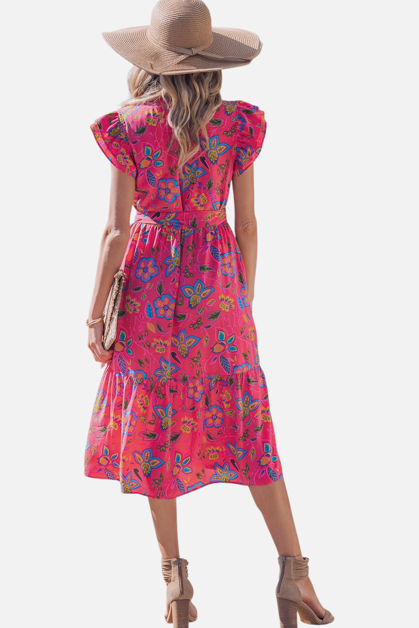 Rear view of a model in a vibrant pink floral midi dress, showing the ruffled cap sleeves, tiered skirt hem, and a flattering cinched waist with a straw hat accessory.