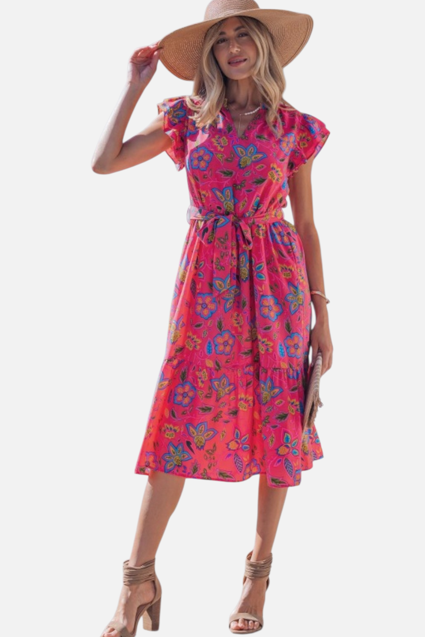 A model showcasing the feminine pink floral dress styled with a wide-brim straw hat and tan heels, emphasizing a perfect summer event outfit.