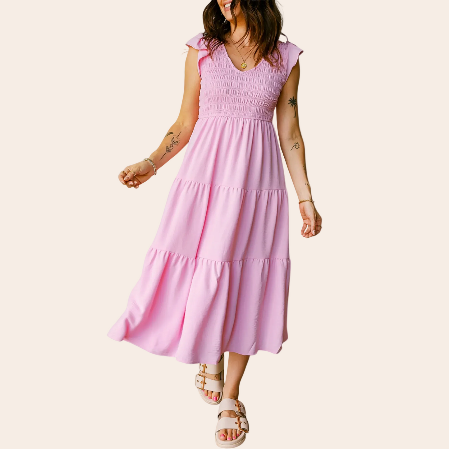 Woman wearing a pink dress on a plain background