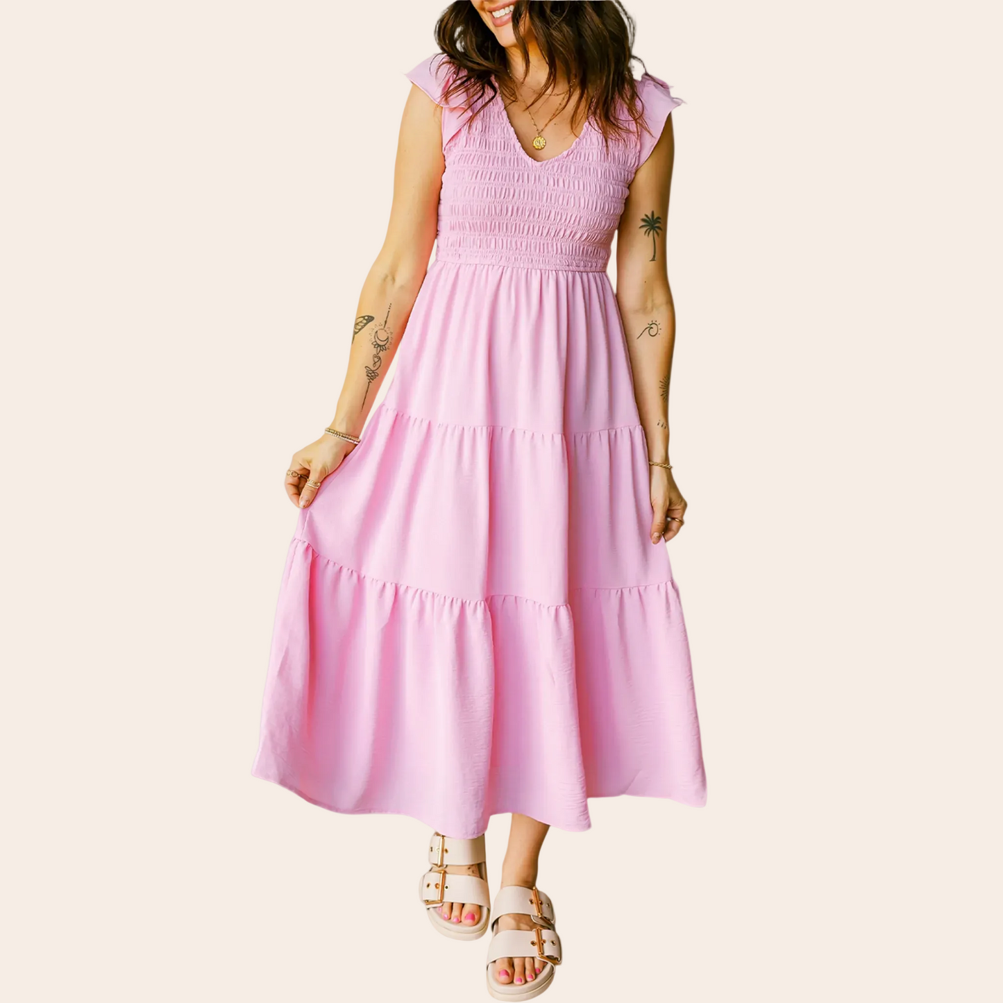 Woman wearing a pink dress against a pink background