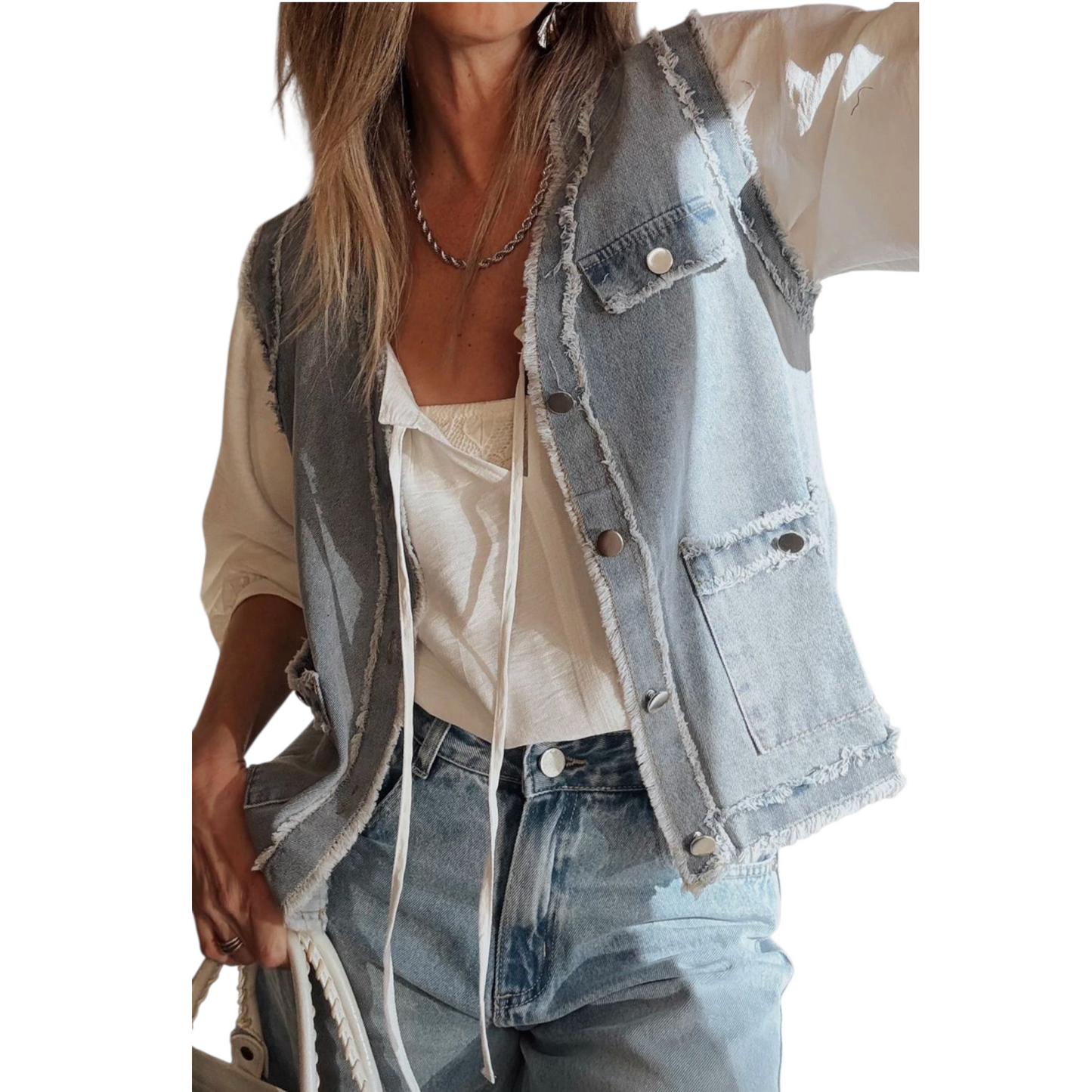 Person wearing a light blue denim vest over a beige shirt with a white background