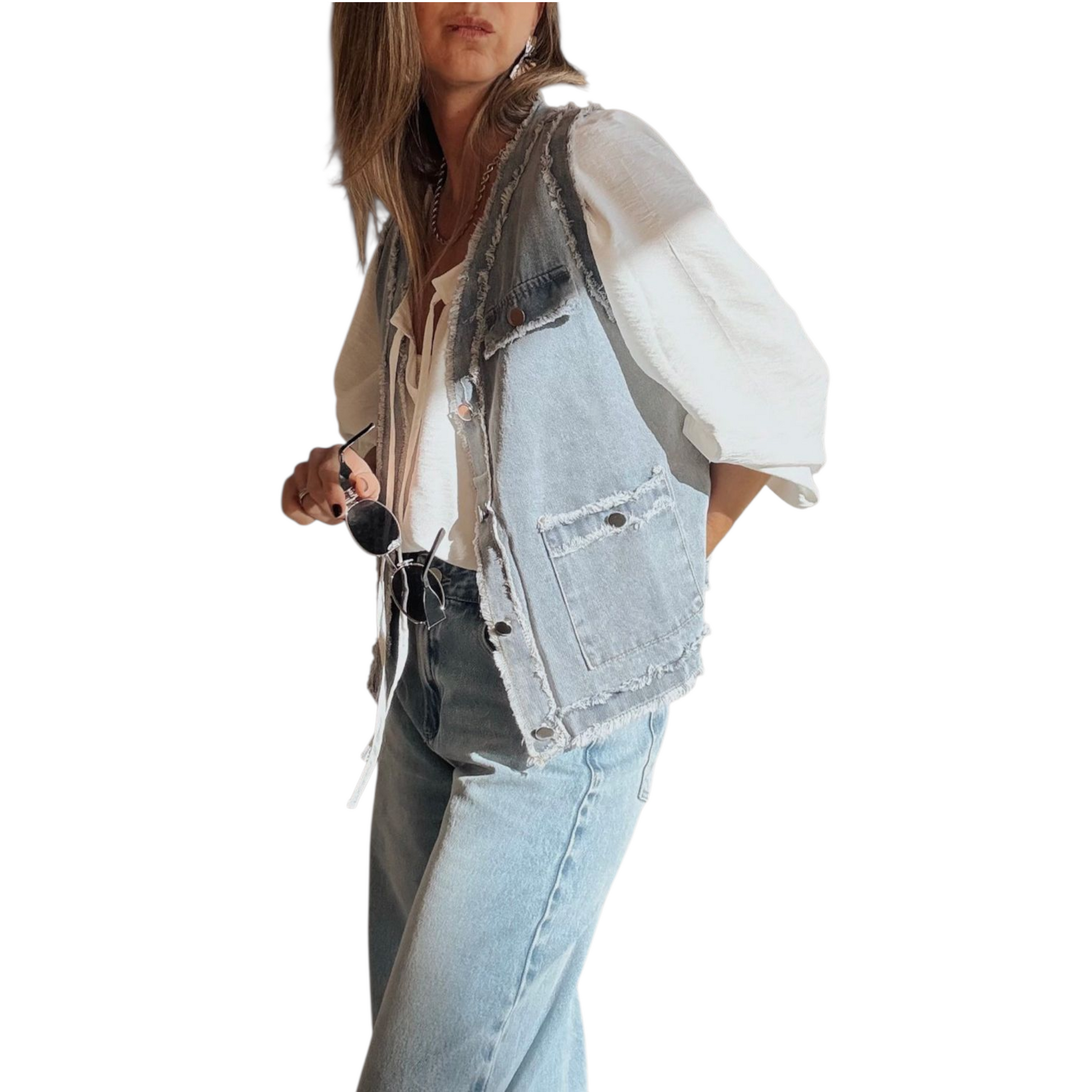 Person wearing a denim vest over a white shirt with light blue jeans on a white background