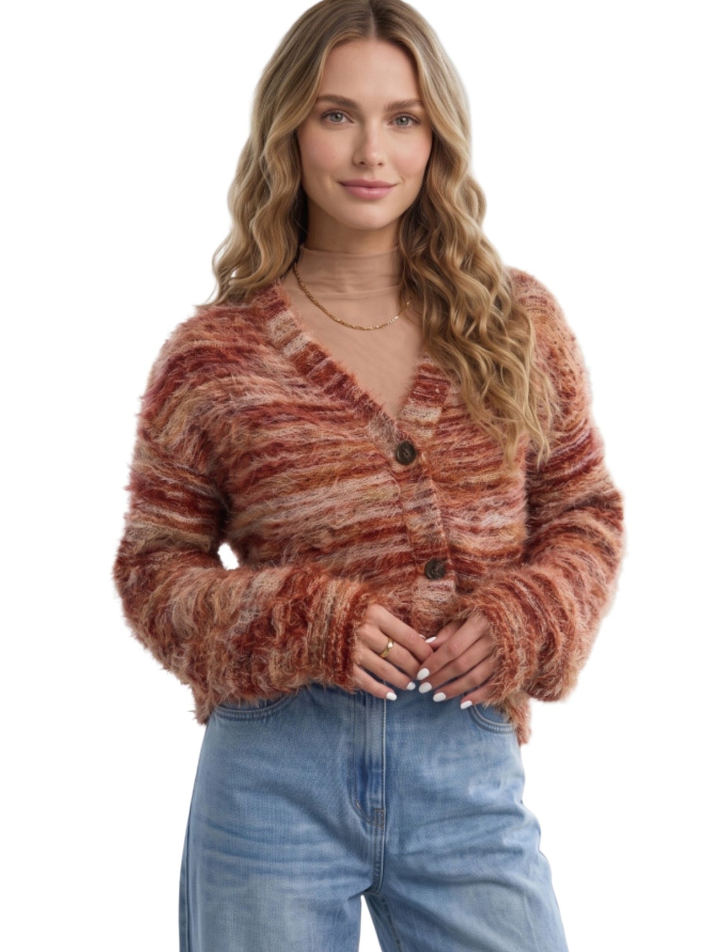 A woman wearing a fuzzy, marled knit cardigan in rust, terracotta, and brown tones, paired with light-wash blue jeans, against a plain white background.