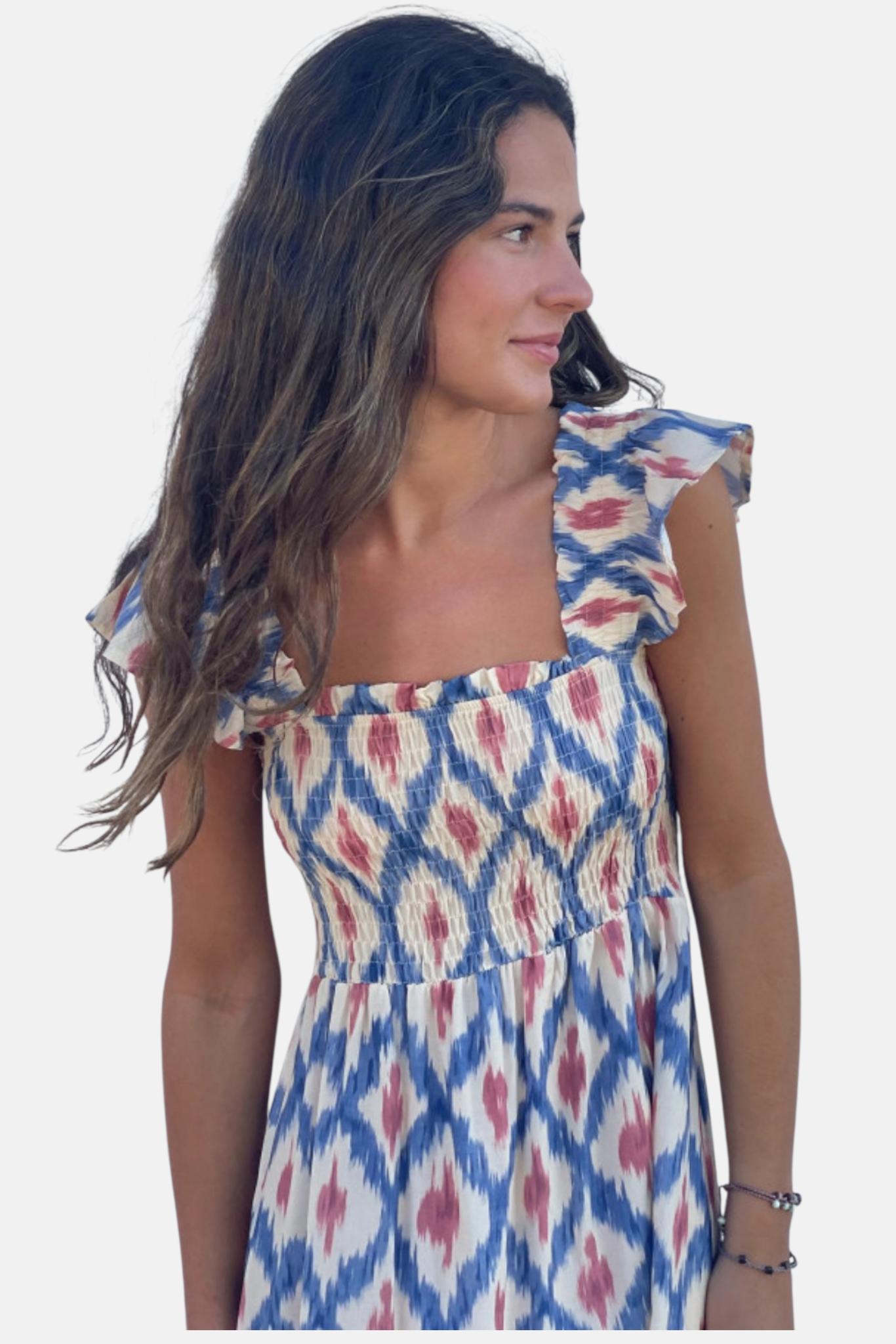 Half-body portrait focusing on the elegant square neckline, elasticated smocking, and delicate ruffled cap sleeves.