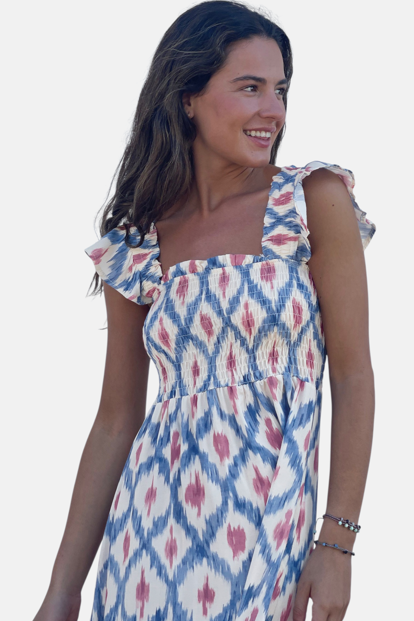 A three-quarter view of the smocked maxi dress, showcasing the intricate blue and pink ethnic geometric pattern.