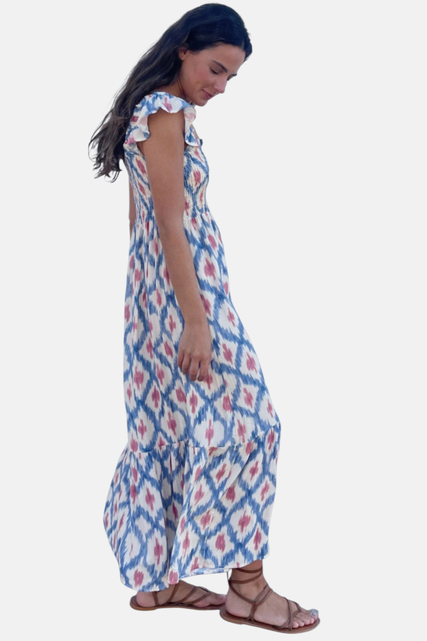 Side profile of the flowy maxi dress, emphasizing the flattering empire waist and the graceful drape of the ruffled skirt.