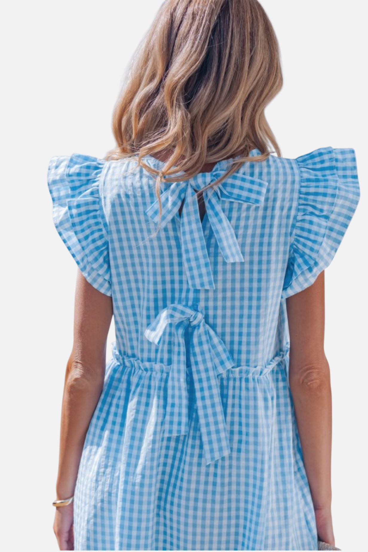 Woman wearing a blue checkered dress with ruffled sleeves on a white background