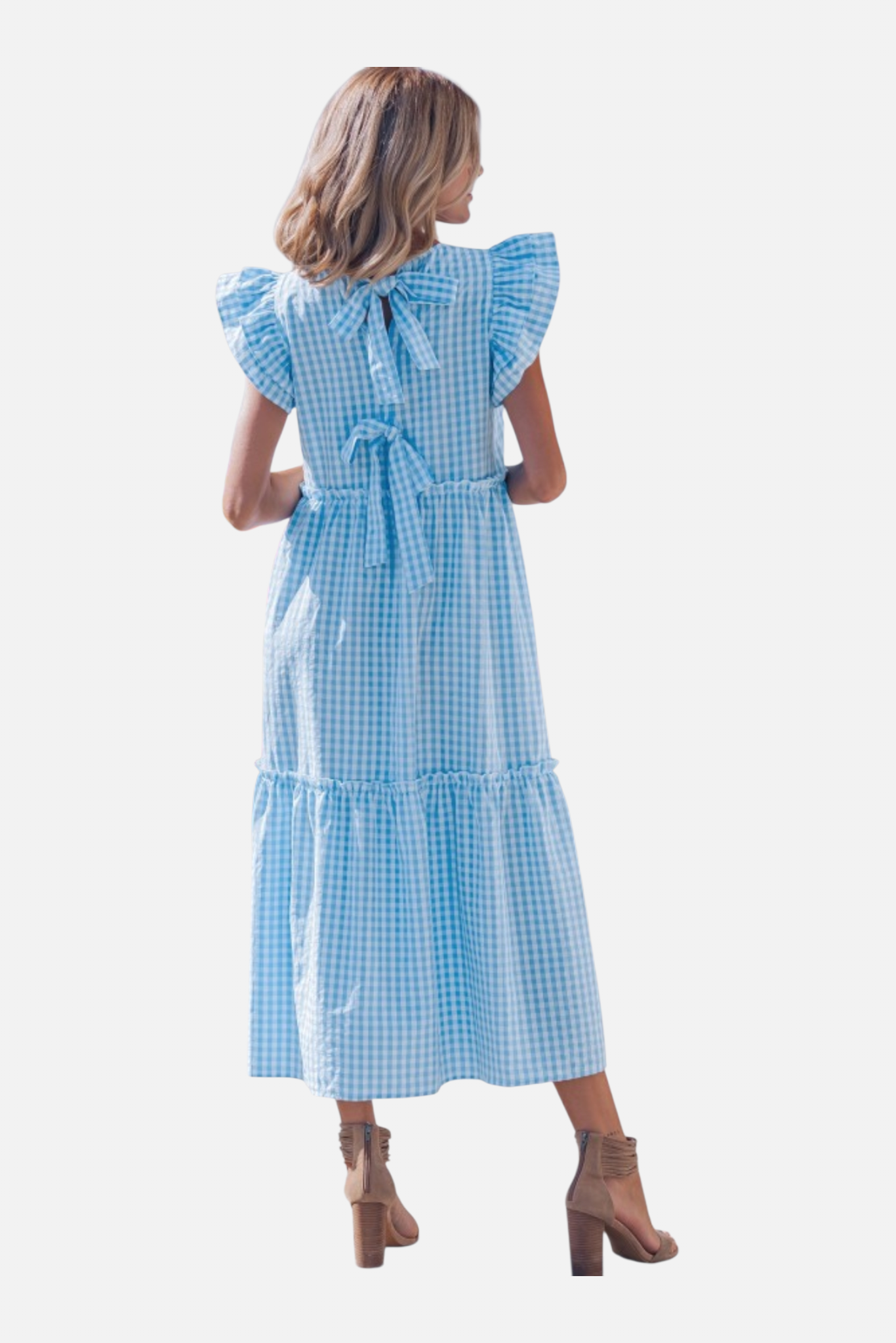 Woman wearing a blue checkered dress on a white background