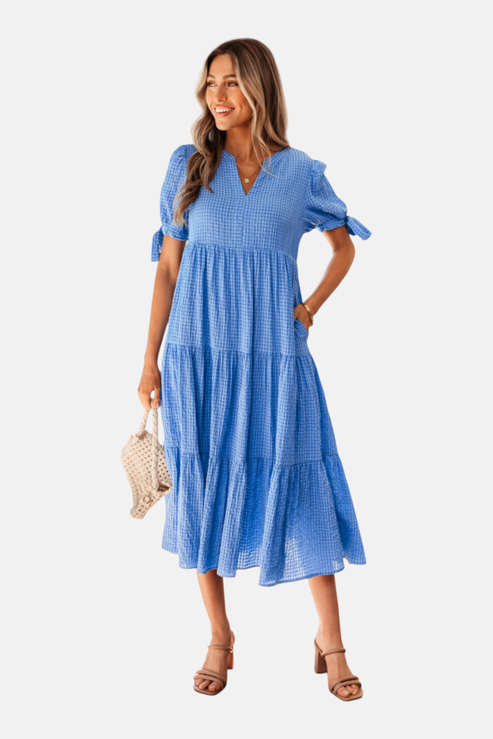 Woman wearing a blue dress on a white background