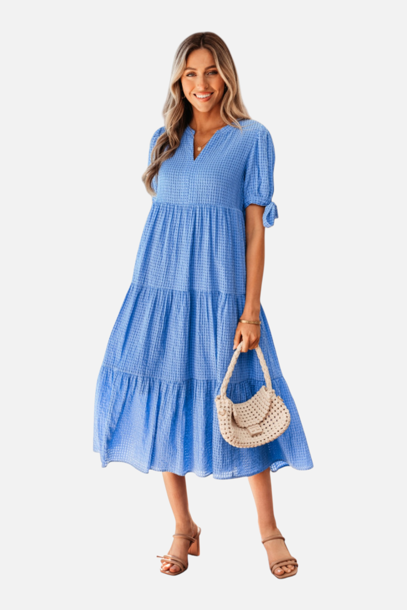 Woman wearing a blue dress holding a straw bag on a white background