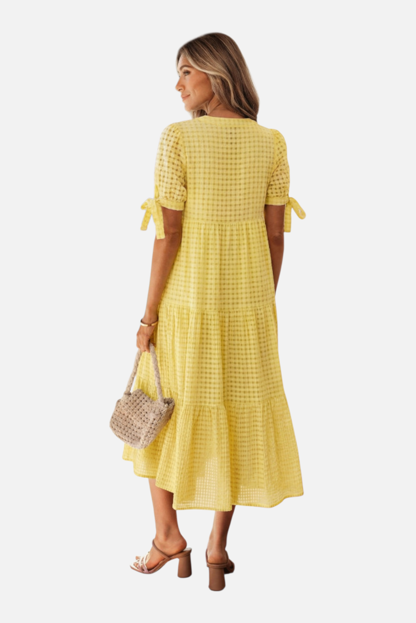 Woman wearing a yellow checkered dress on a white background