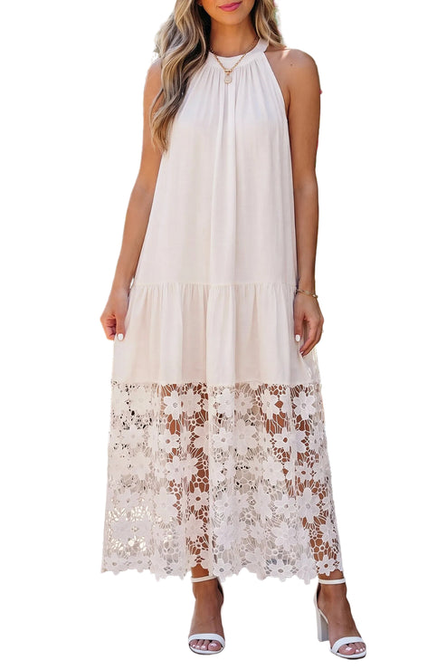 Woman wearing a white halter neck dress with lace details on a white background