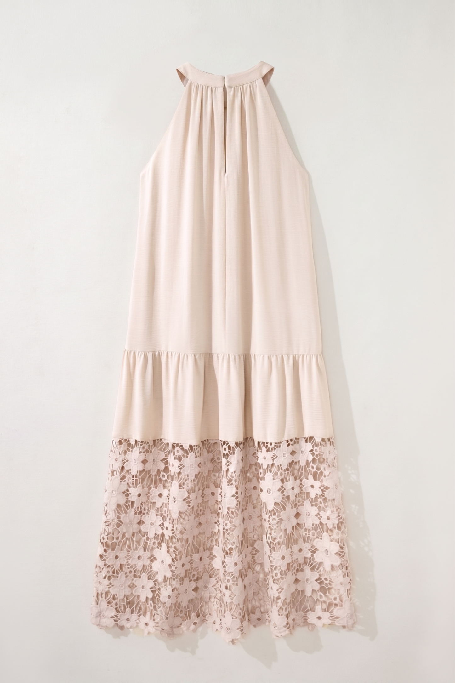 Beige dress with floral lace hem on a white background