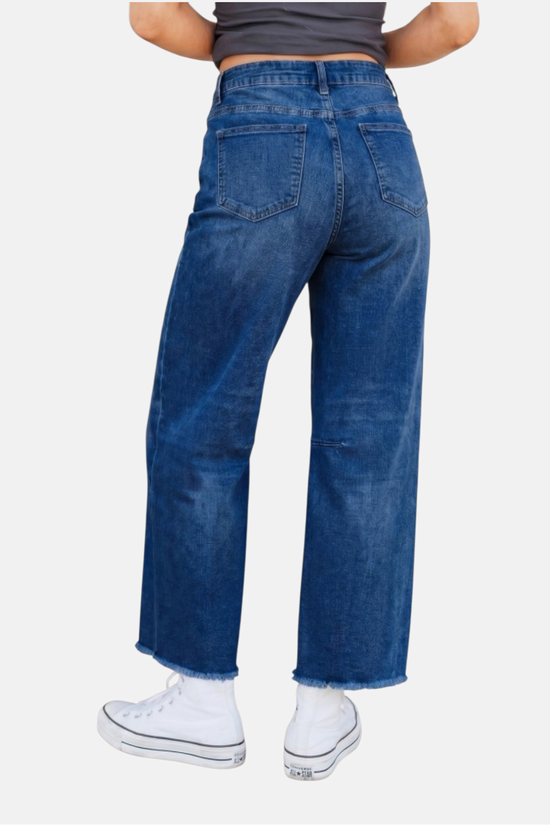 Person wearing blue jeans on a white background