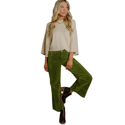 Full front view of a person wearing olive green wide-leg corduroy pants with a high waist and dark brown ankle boots.