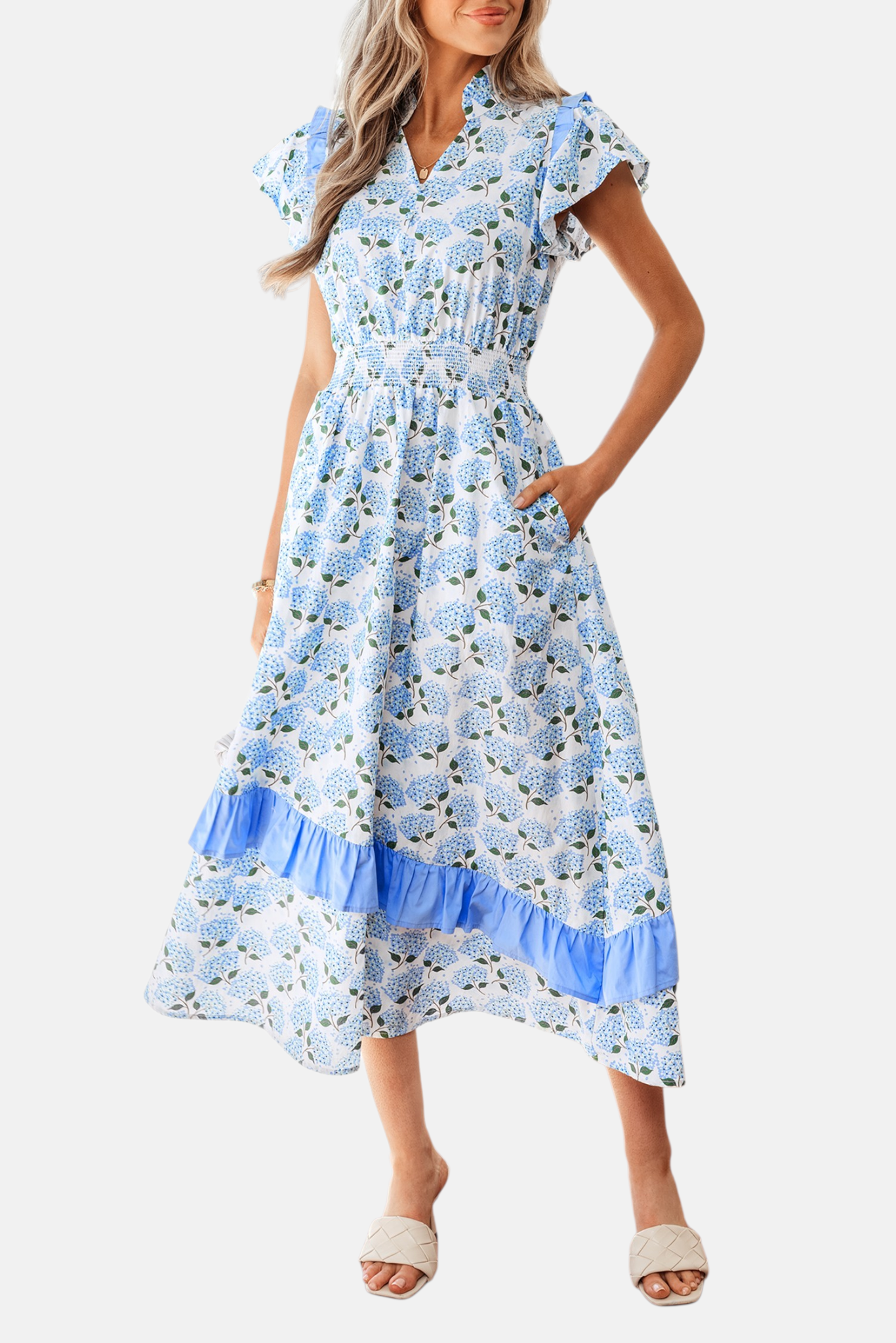 Detail shot of the hydrangea floral midi dress highlighting the functional side seam pockets and the intricate smocked waistband.