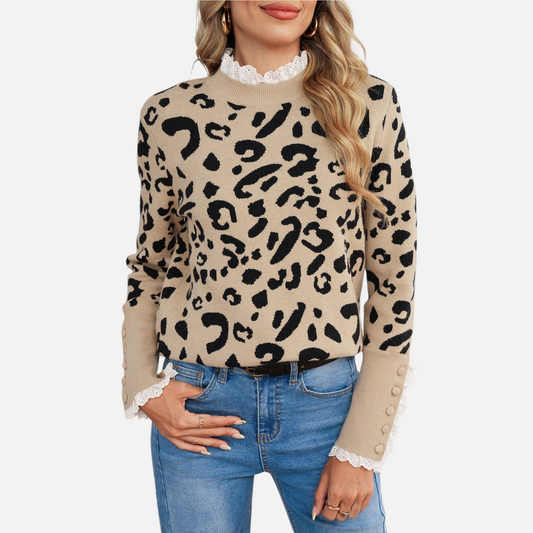 Model wearing the leopard print knit sweater paired with blue jeans, showcasing the elongated ribbed cuffs with decorative tonal buttons.