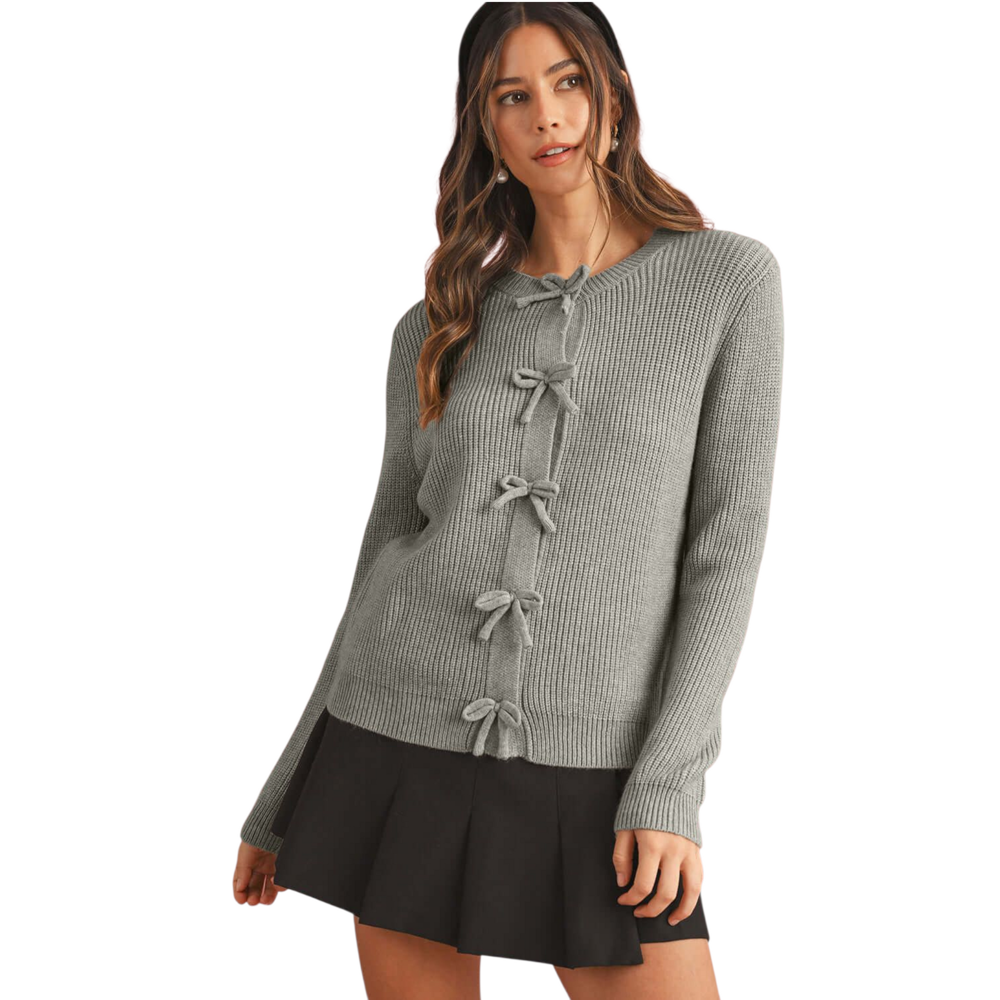 Woman wearing a gray sweater with bow details on a white background