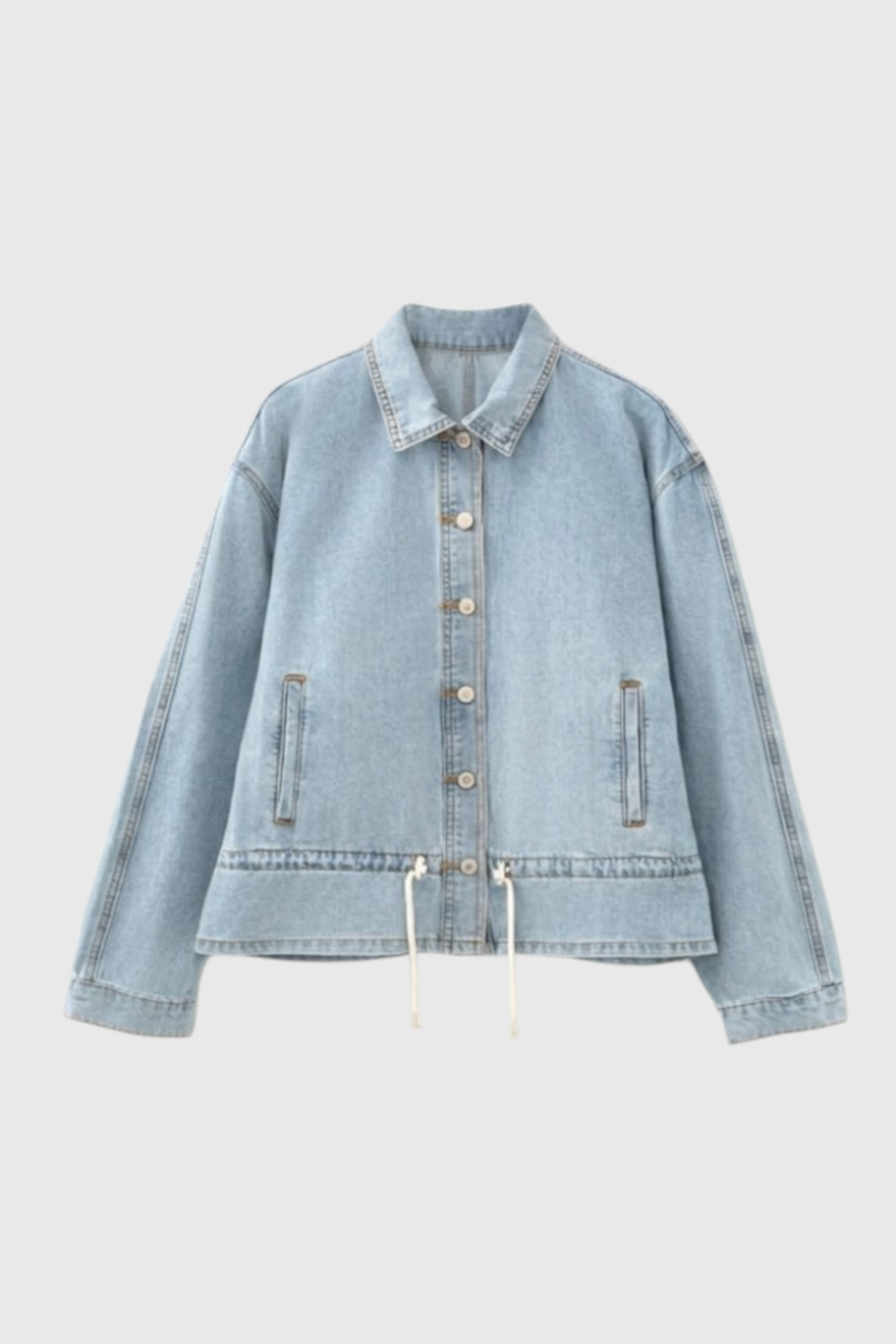 Front flat lay of a light wash denim drawstring jacket featuring a classic collar, button-down front, and subtle side pockets.