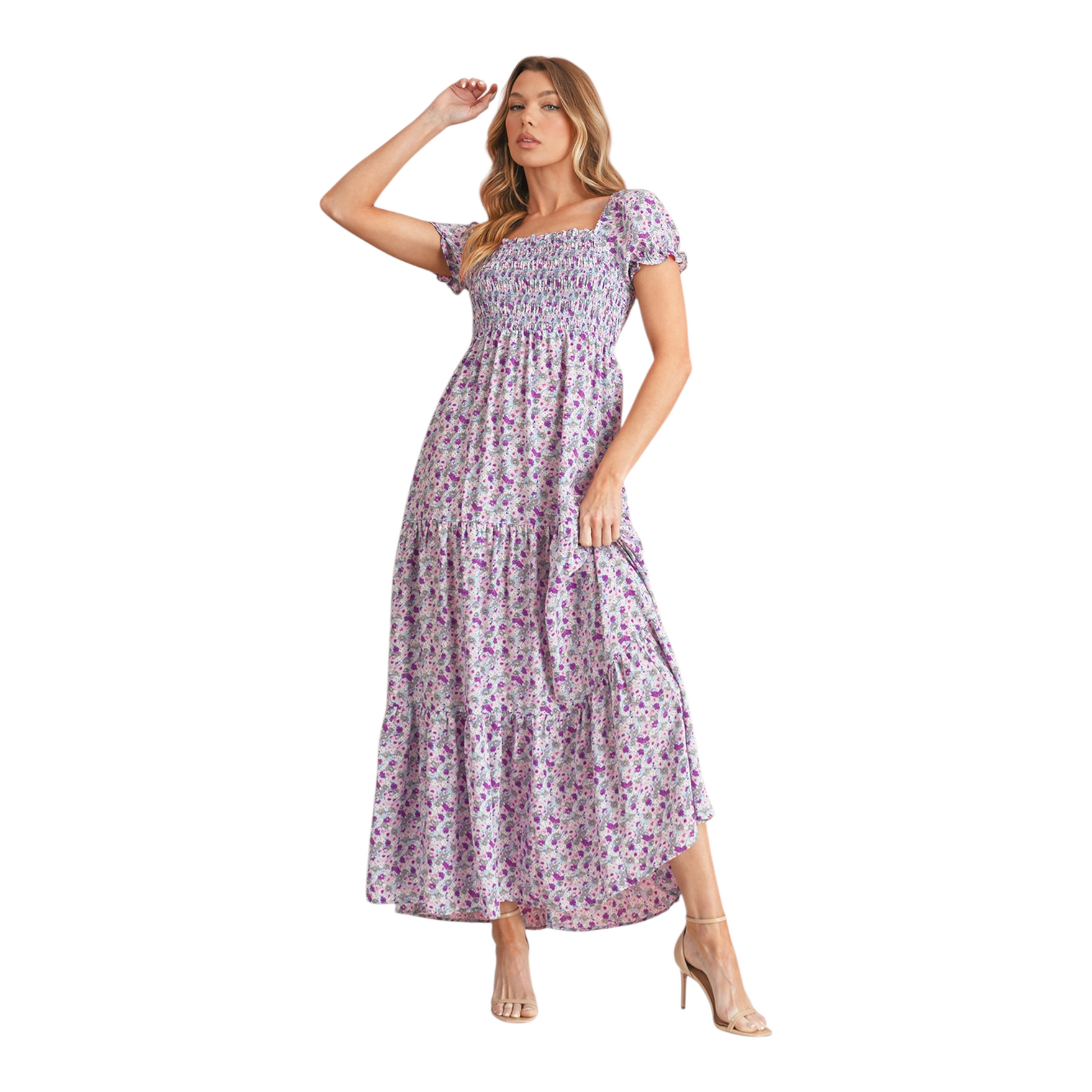 Model wearing a lilac and purple floral smocked maxi dress with short puff sleeves and a tiered skirt. The dress features a square neckline and an elasticated smocked bodice for a flattering fit.