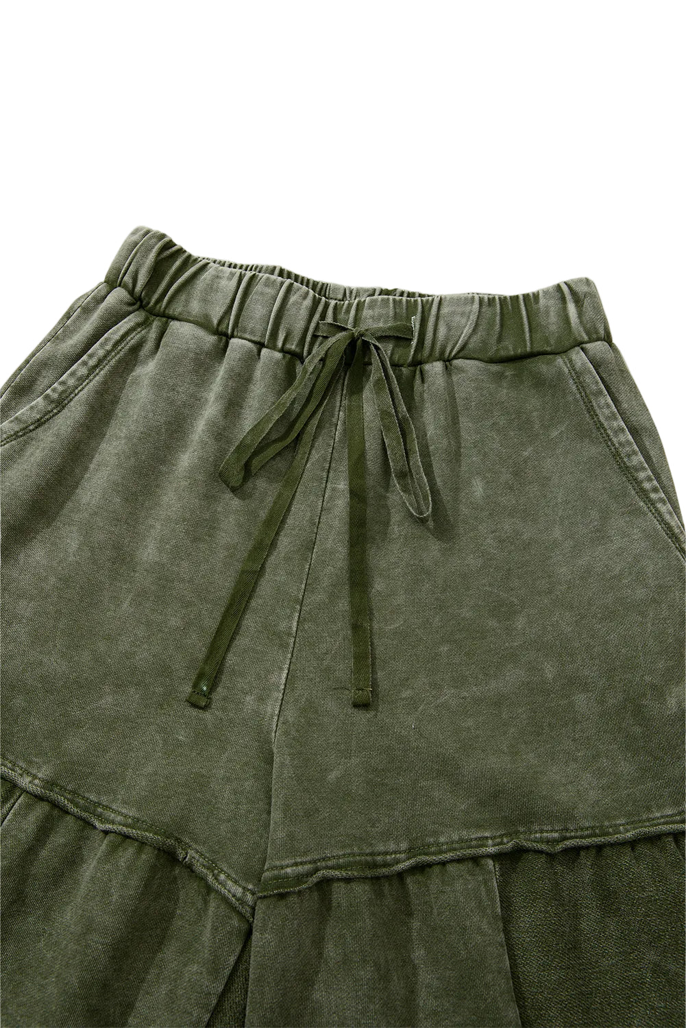 Green tiered pants with drawstring waist on a white background