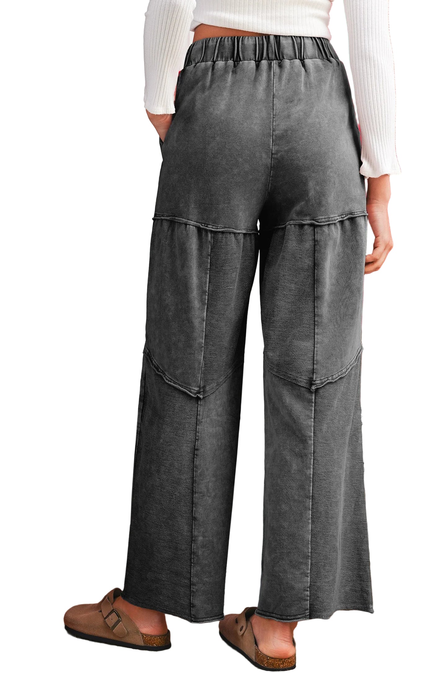 Back profile of a dark gray wide-leg pants worn by a person on a white background