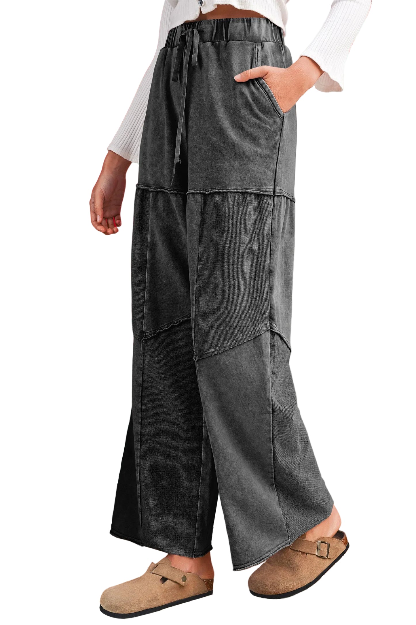 Gray wide-leg pants with pockets worn by a person on a white background