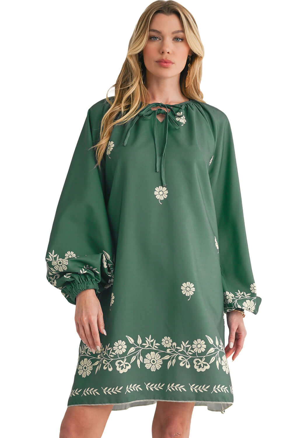 Full view of a mist green boho floral mini dress with long sleeves, ideal for casual outings - set against a white background.